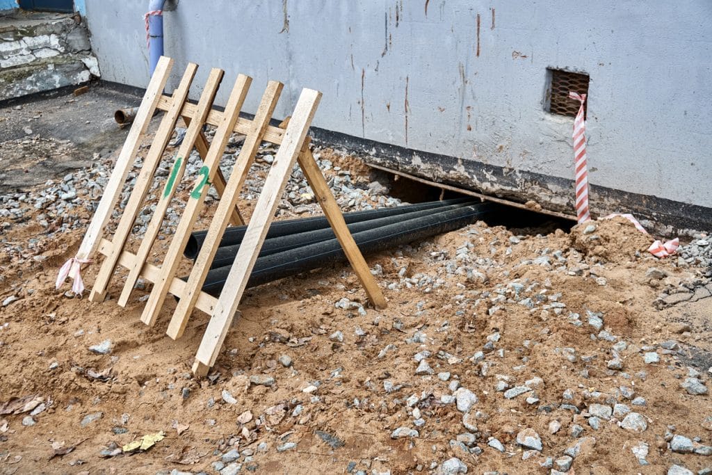 pipes digging under old building